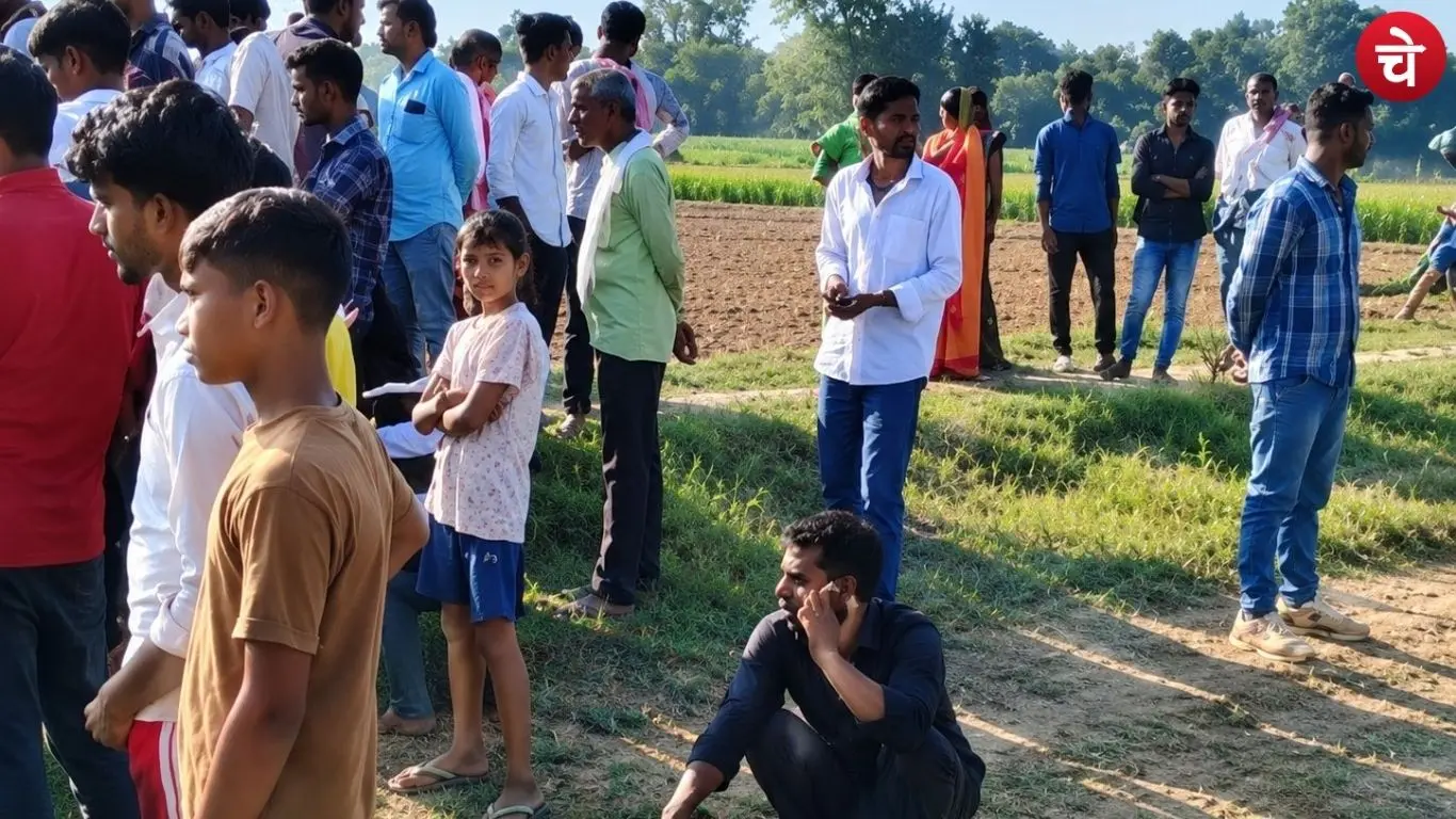 Villagers gathered in a field in Ambedkarnagar after the bodies of a couple were discovered there